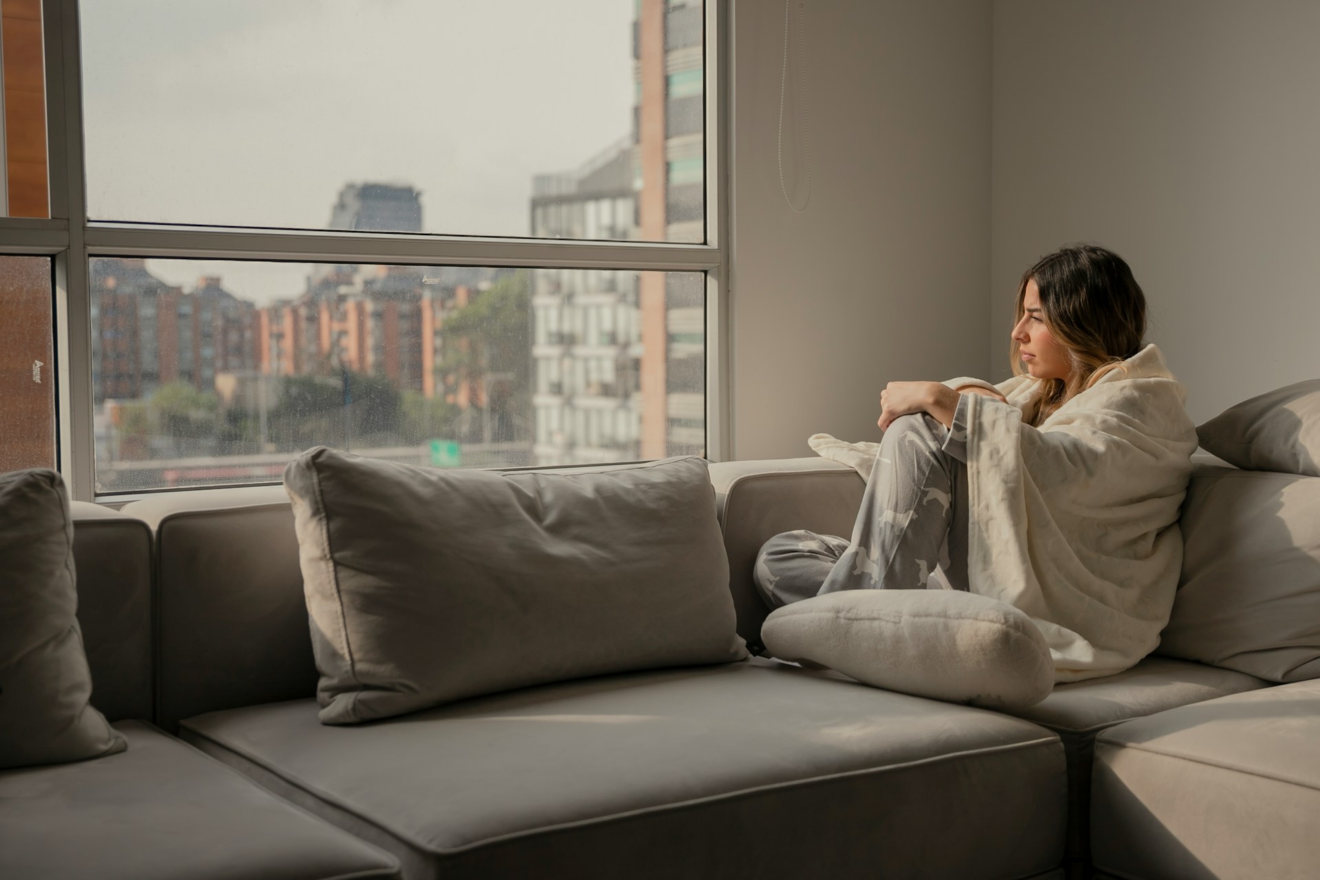 woman at home covered in a blanket